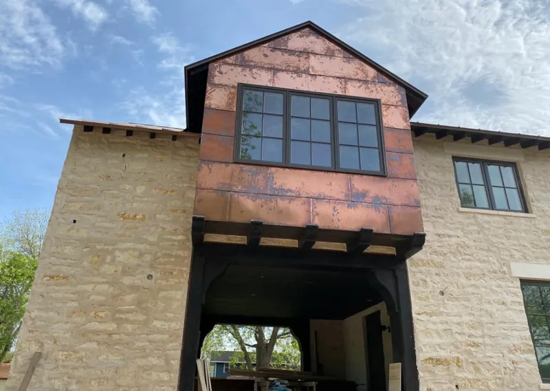 Copper metal panel facade on a stone building for Skylight Installation in Balch Springs